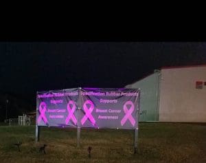 Banners outside of the Specification Rubber Products Headquarters showing support for Breast Cancer Awareneness